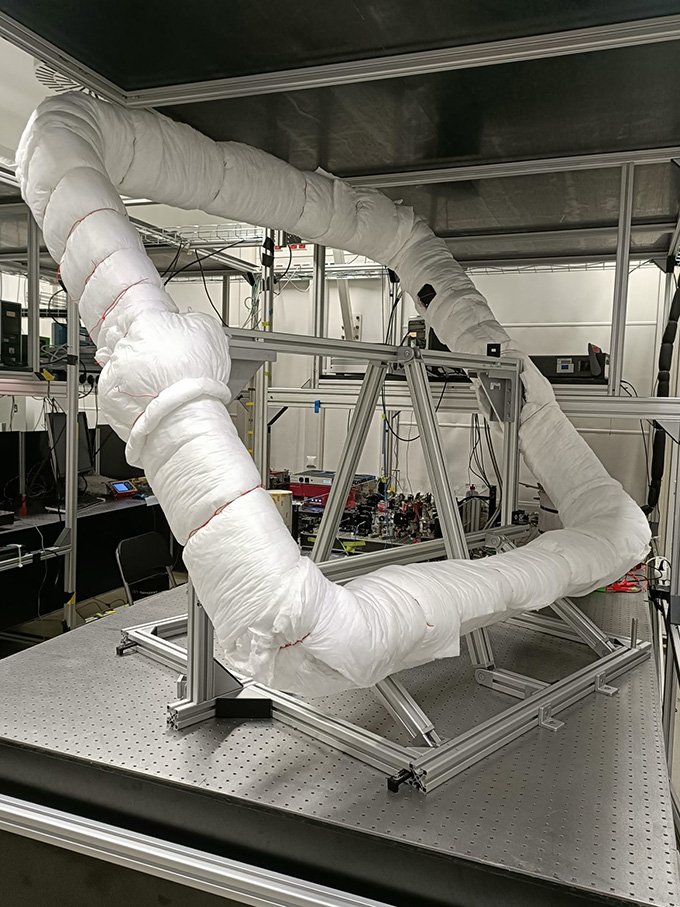 A square frame holding an interferometer sits on a table in a laboratory.